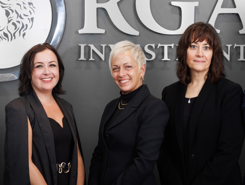 Three RGA Investments team members in front of the RGA logo